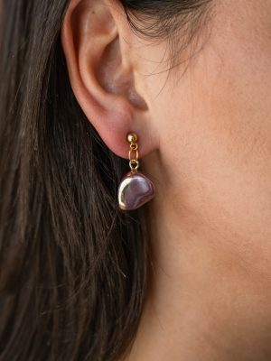 Κομψό σκουλαρίκι σε ατσάλινη βάση και ημιπολύτιμη πέτρα, σε απόχρωση του μωβ. Ιδανικό για καθημερινή χρήση . Το ακανόνιστο σχήμα της πέτρας προσθέτει μοναδικότητα σε κάθε τεμάχιο .